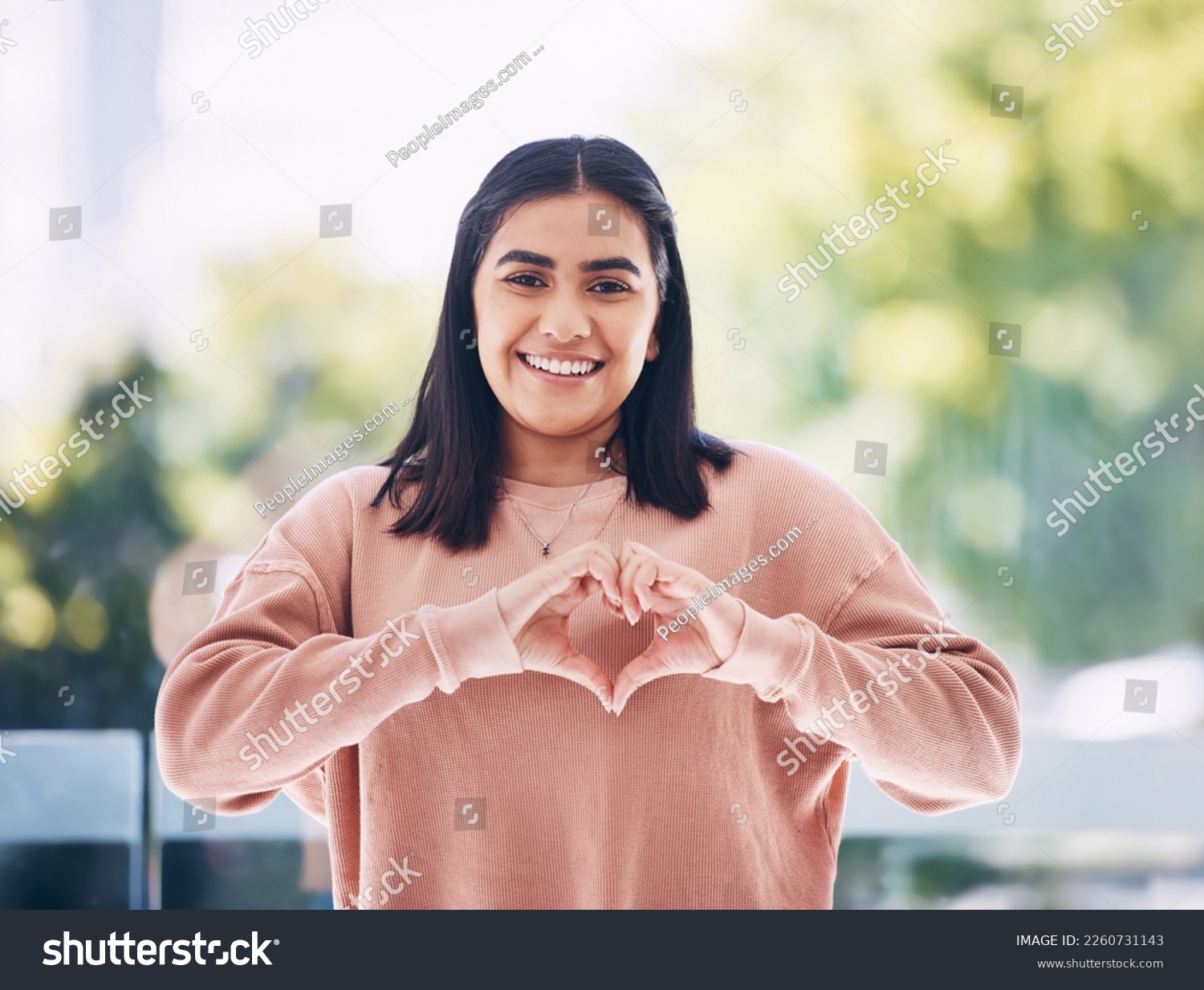 Portrait, heart hands and young woman for self care, cardiology wellness and gen z support for women health. Face of a happy Indian person with love emoji, sign or gesture for like, vote and peace #2260731143