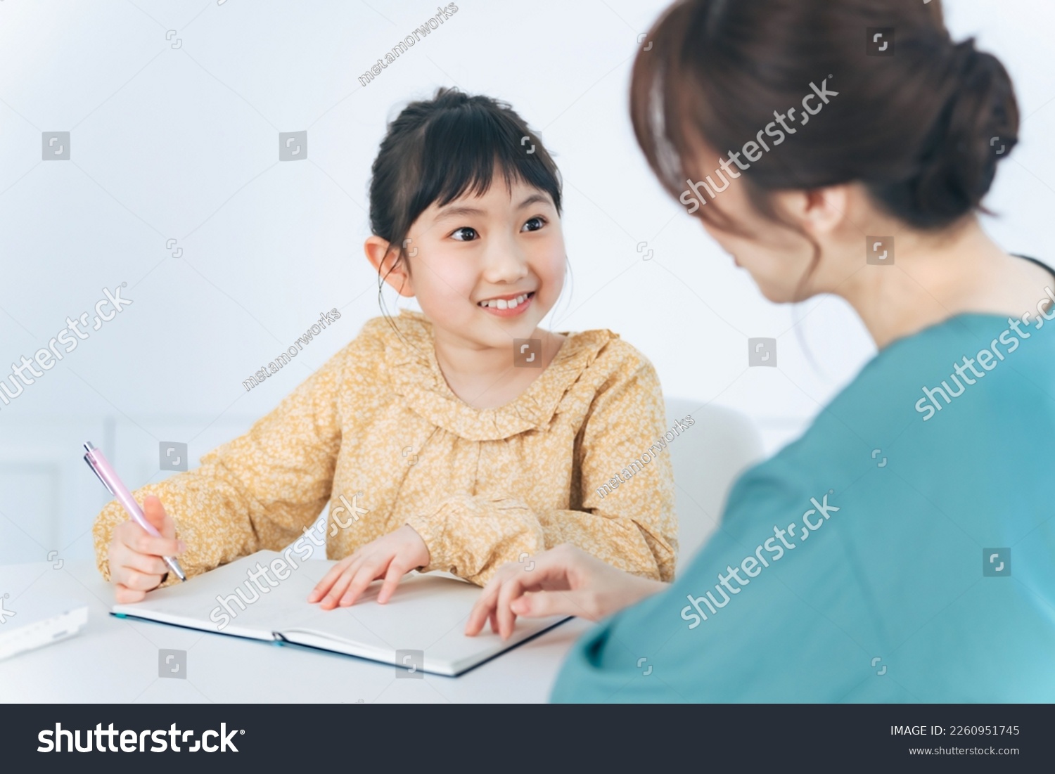 Asian woman teaching little girl. Mother and daughter. Cram school. Tutor. #2260951745