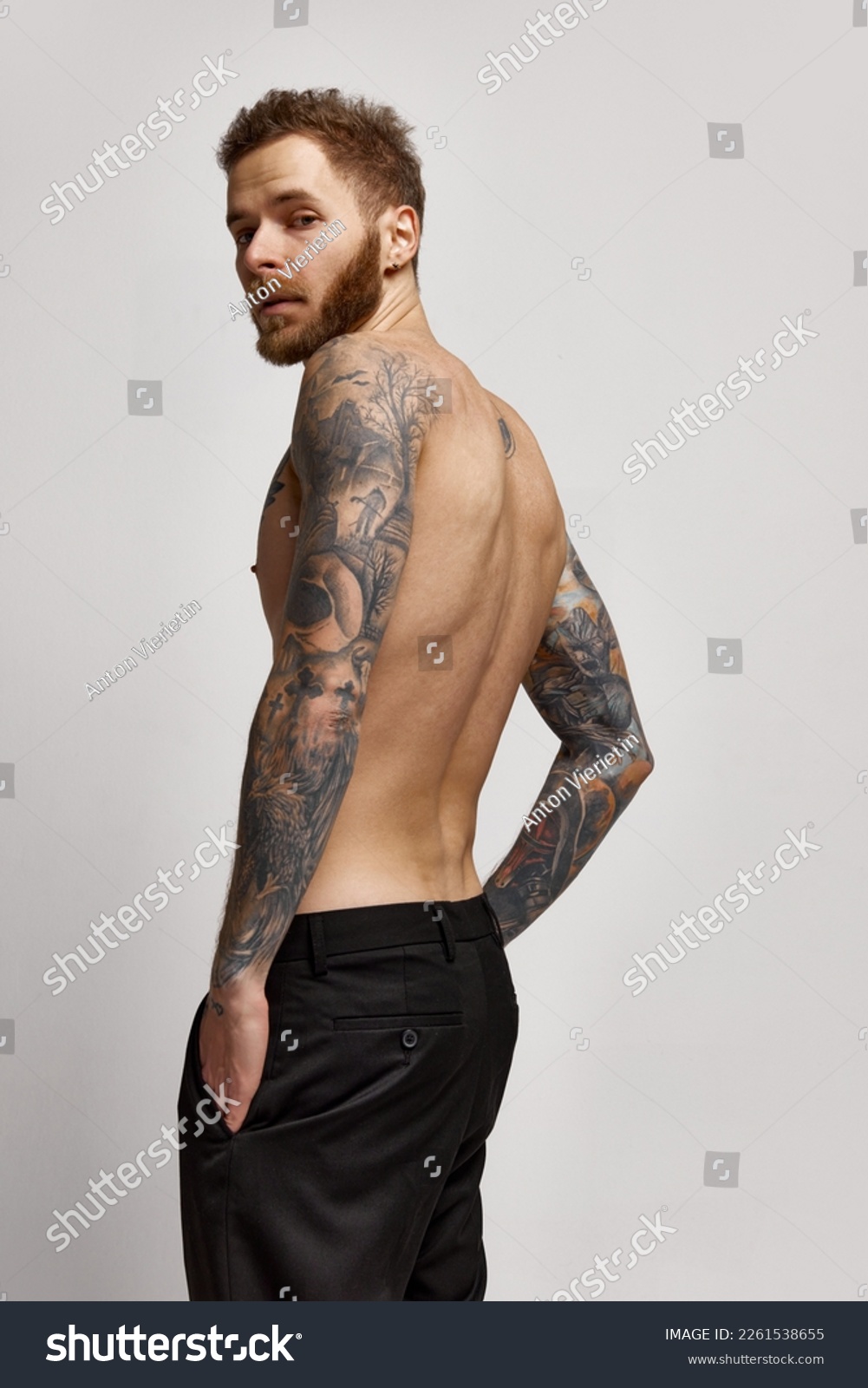 Elegance and courage. Young 30 years old man posing shirtless. Perfect muscular body shape. Tattoo body art. Concept of fashion, style, body aesthetics, beauty, men's health. #2261538655
