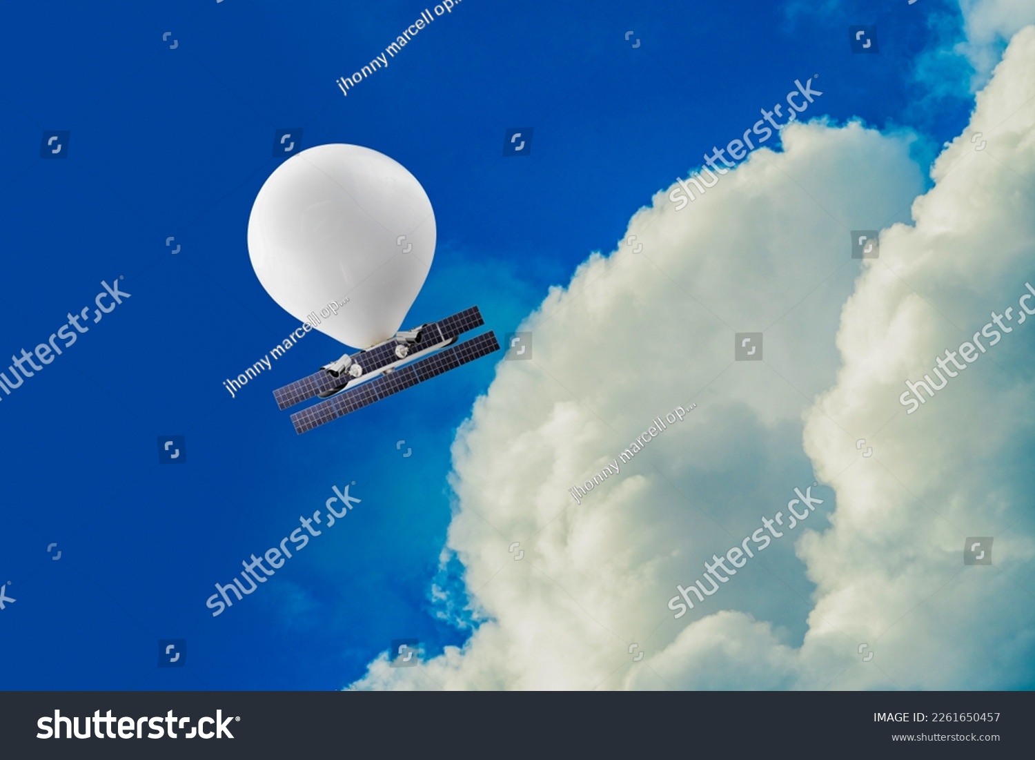 stratospheric balloon, complete with solar panels and cameras, travels at an altitude well above commercial air traffic in a blue sky #2261650457