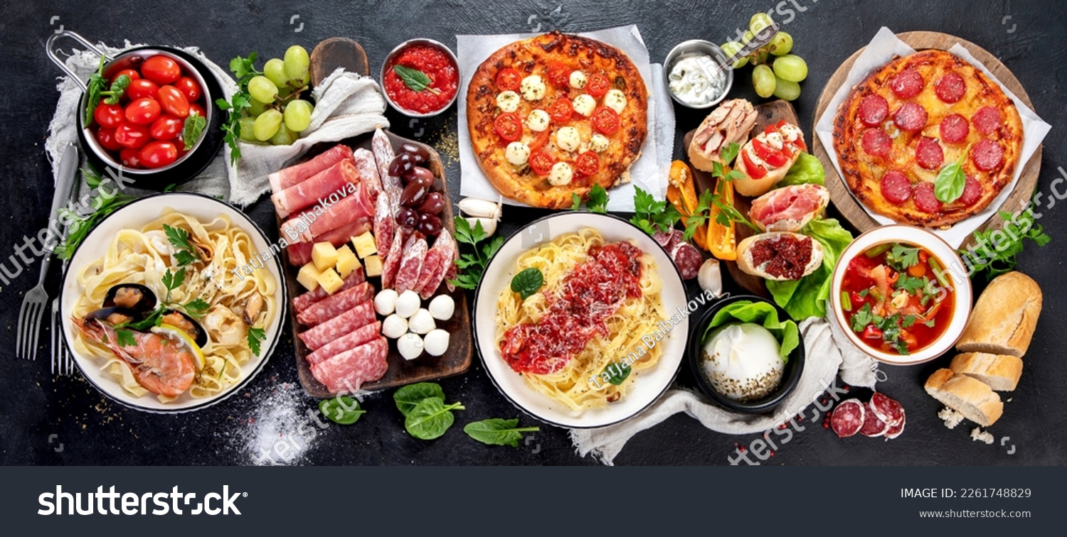 Italian food dishes on dark background. Traditional italian cuisine  concept. Dishes and appetizers of indeed cuisine. Mideterranean diet high in vitamin and antioxidants. Top view, panorama, banner #2261748829
