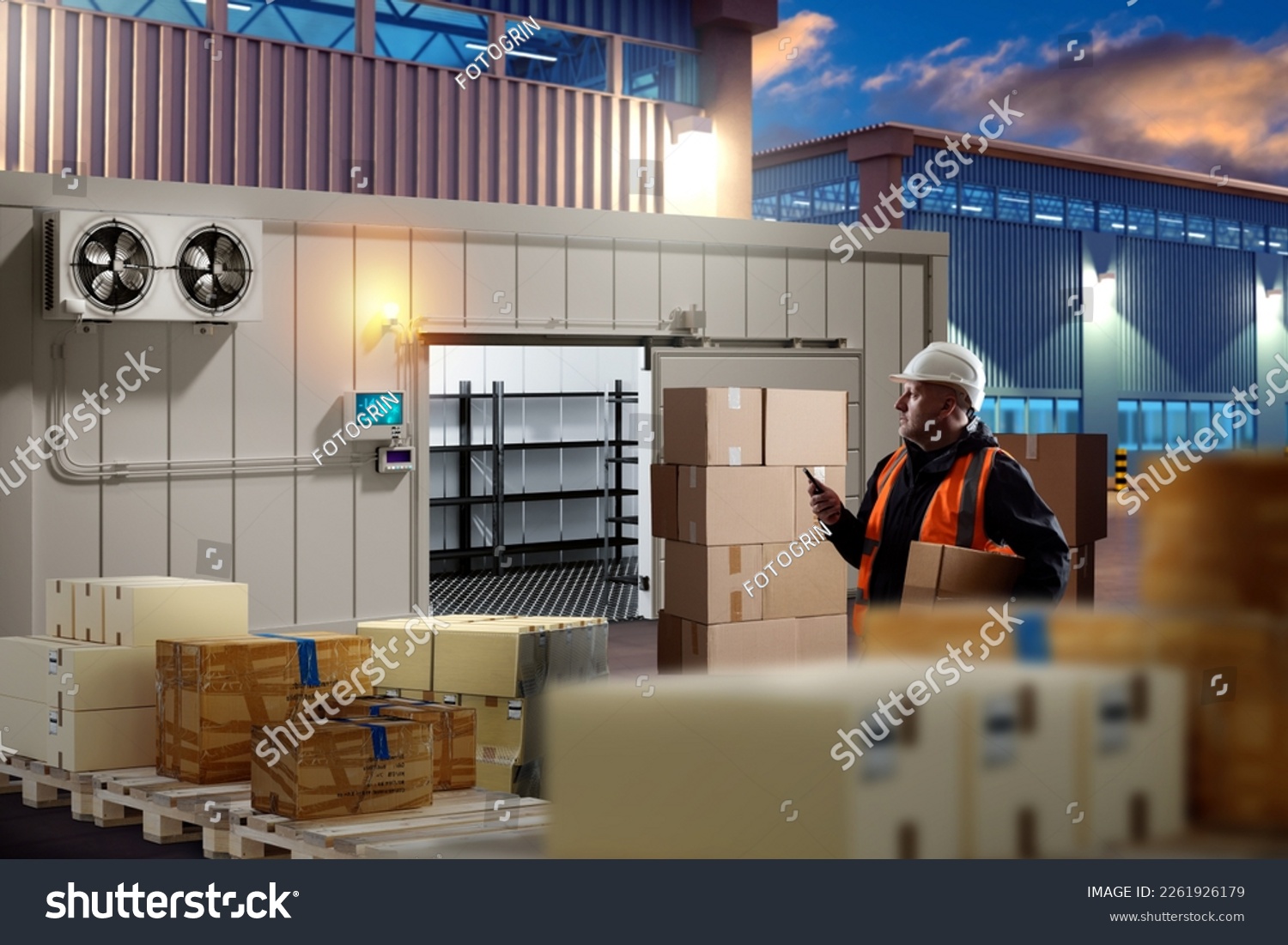 Man near industrial refrigerator. Boxes on pallets near cold room. Guy brings boxes into cold room. Cold rooms in industrial zone. Outdoor freezer for storage. Man storekeeper working in evening #2261926179