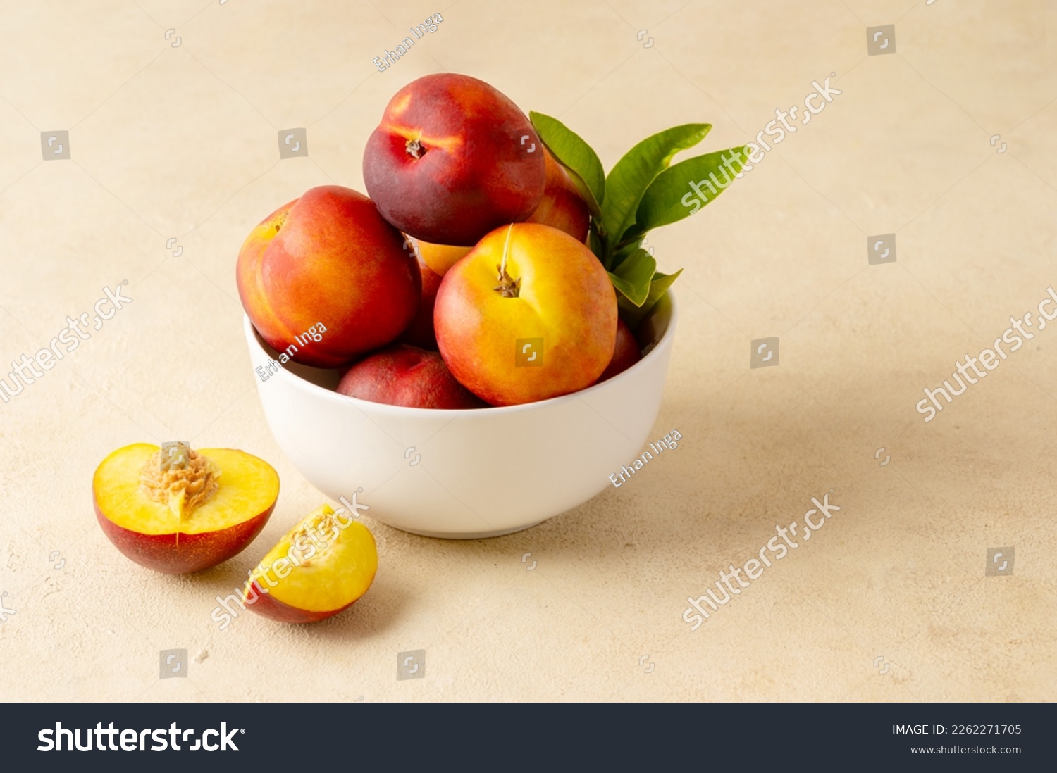 Whole nectarine peaches, fresh red fruits in a bowl. Neutral background. #2262271705