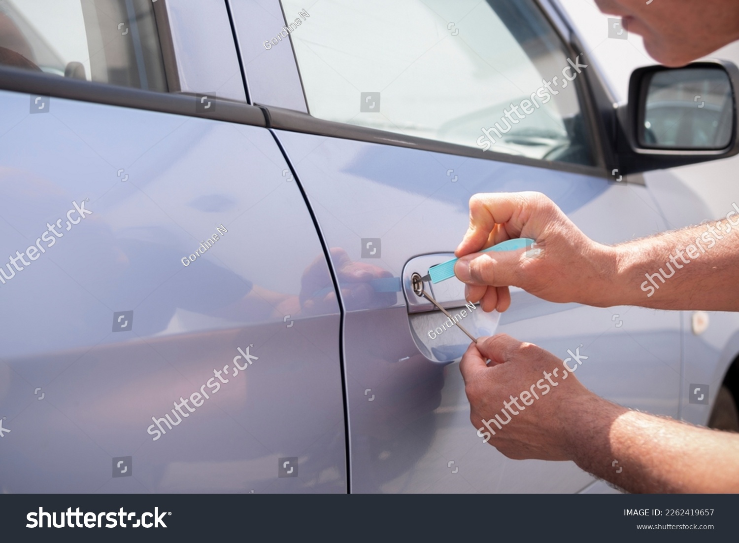 Locksmith opening a locked car door #2262419657