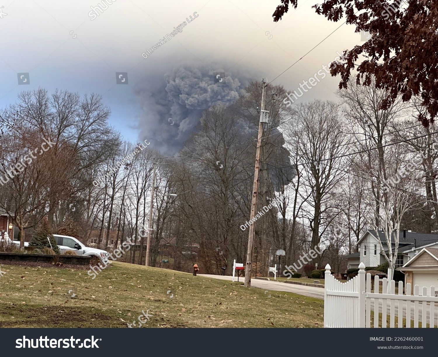 The rising smoke cloud after authorities released chemicals from a train derailment as seen from the ground in a nearby neighborhood. Photo credit: RJ Bobin. #2262460001