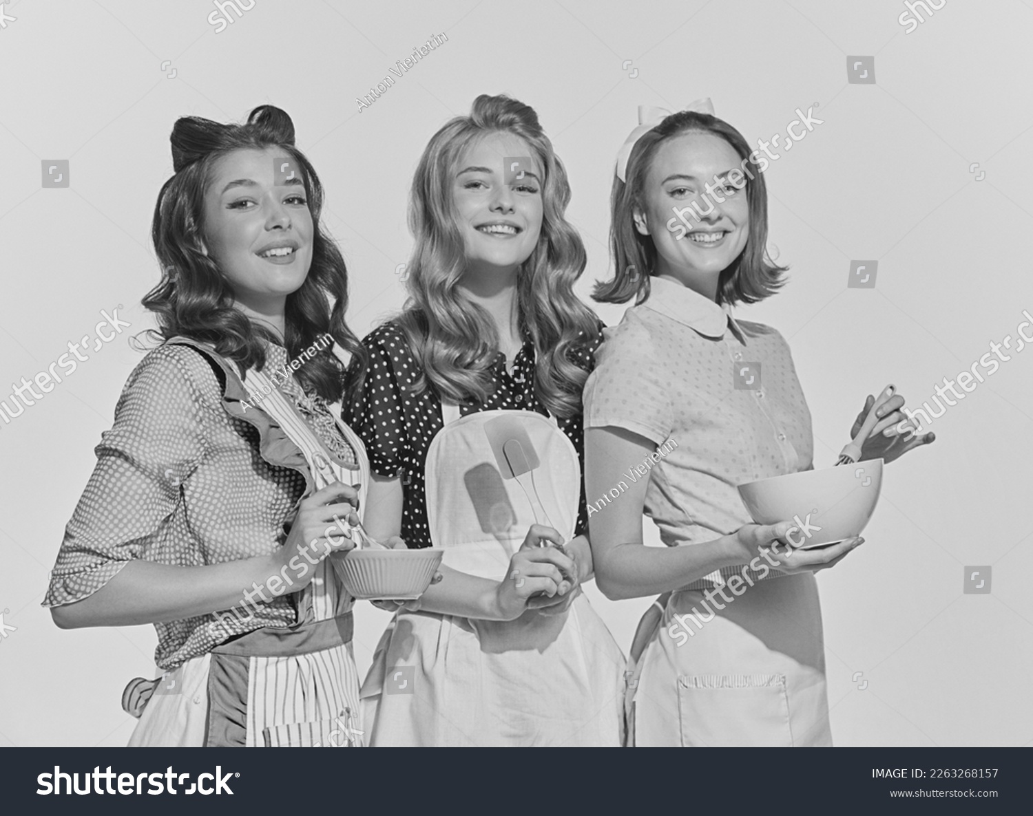 Retro style portrait of beautiful young women, housewives with cooking tools. Black and white image in vintage style. Concept of beauty, retro style, fashion, elegance, 60s, 70s, family. #2263268157