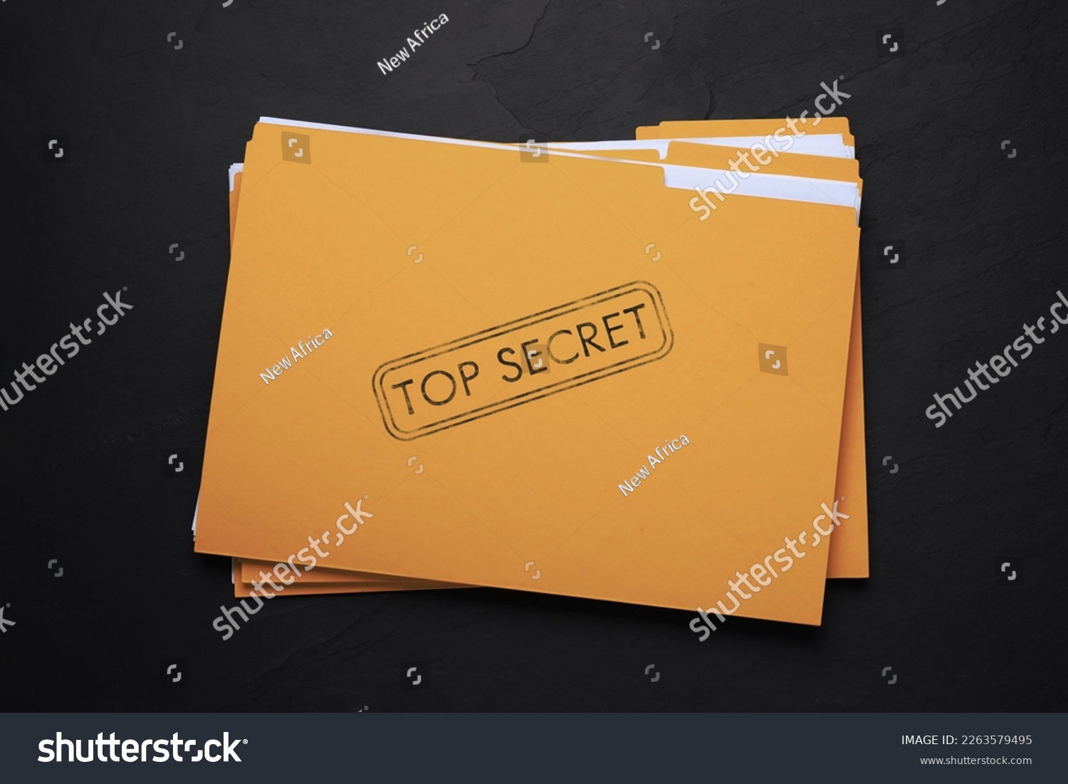 Yellow file with documents and Top Secret stamp on black table, top view #2263579495