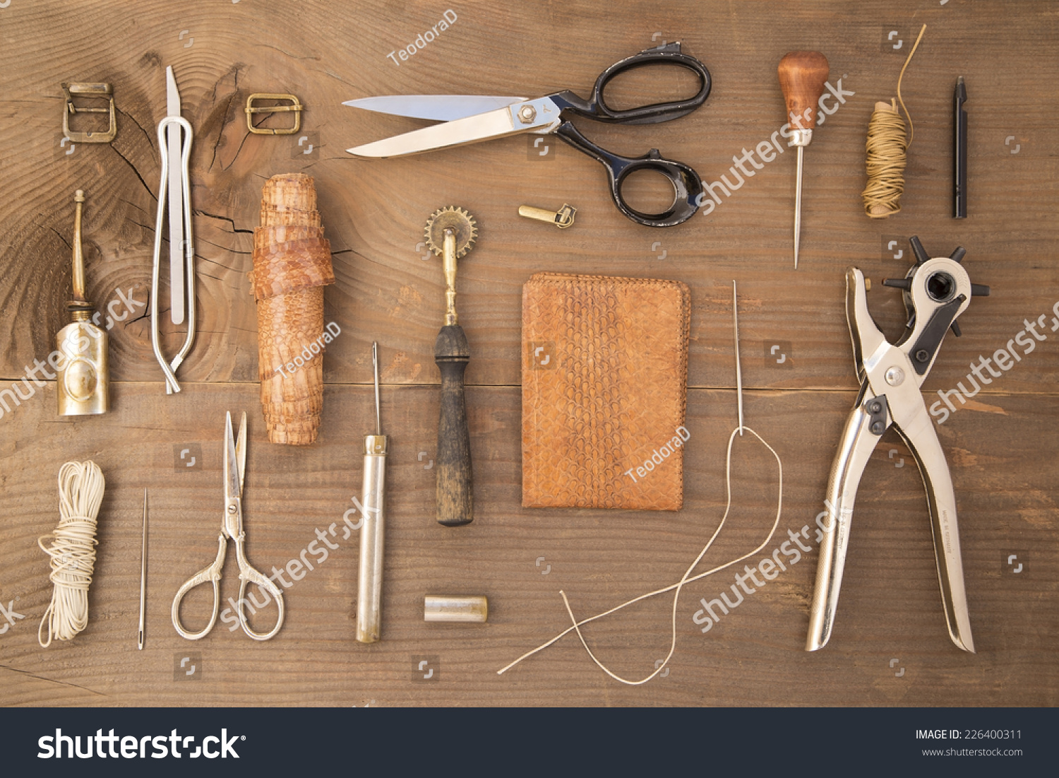 Leather craft tools on a wooden background #226400311