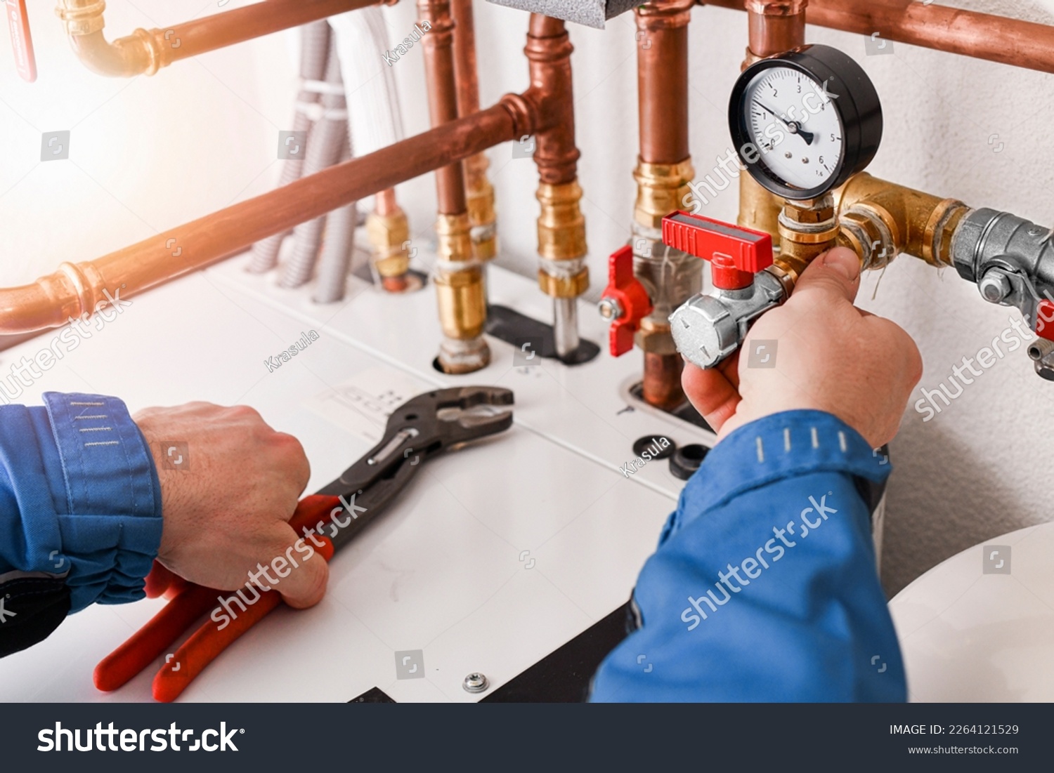 Plumbing concept or service water worker. copper pipeline of a heating system in technical room. Boiler and expansion expansion tank system, detail of pressure gauge. #2264121529