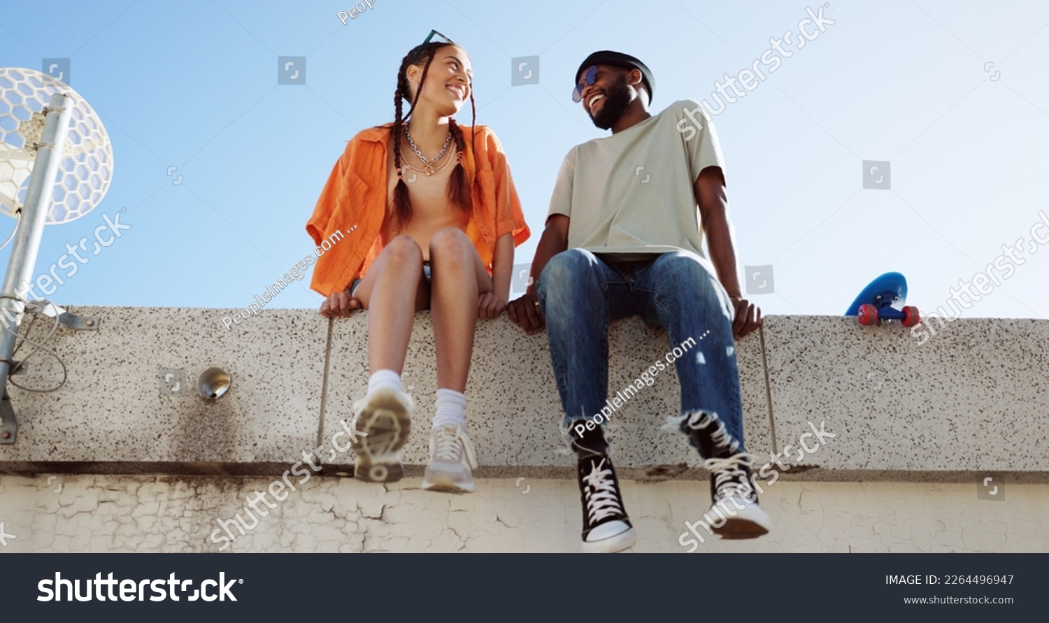 Cool, fashion and joke with young couple hang out on city building together bonding. Interracial stylish young people on a funny city date. Silly, goofy and laughing black man and woman joking #2264496947