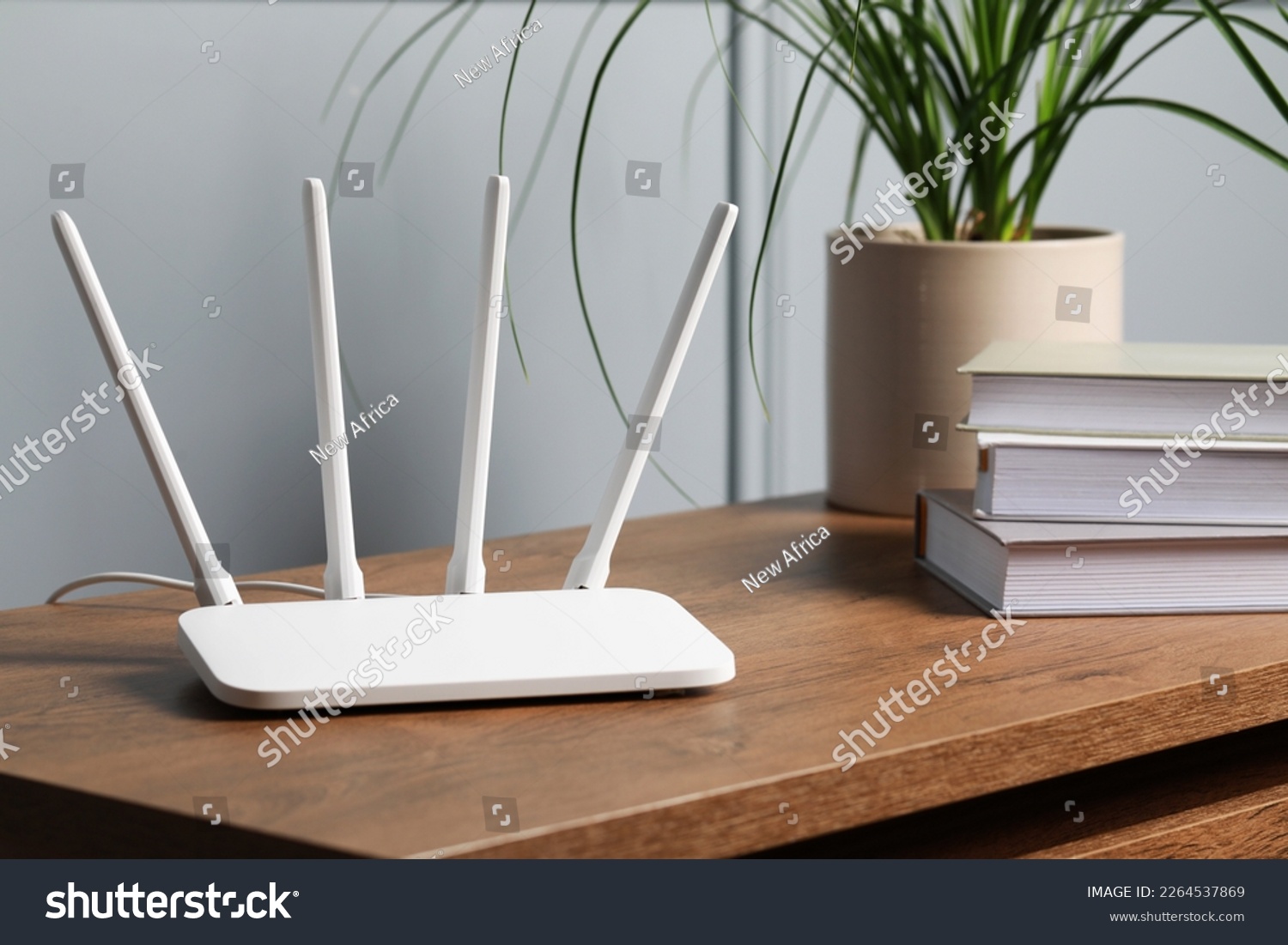 New white Wi-Fi router on wooden table indoors #2264537869