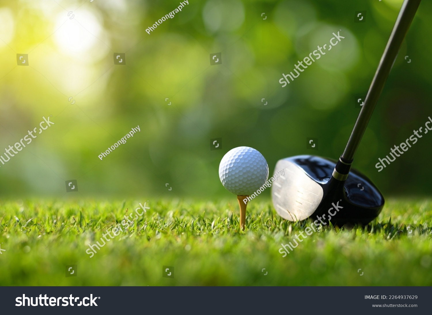 Close-up golf ball on tee with golf drivers at golf course. #2264937629