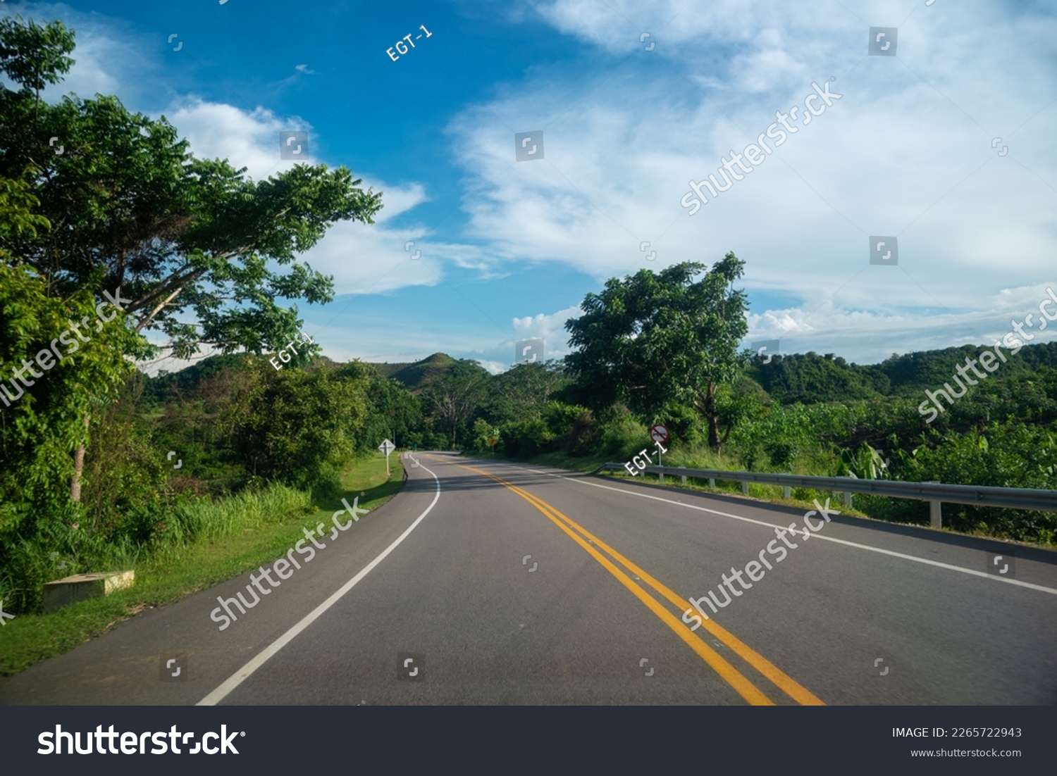 Highway in the Colombian countryside with a no overtaking traffic sign on the road. #2265722943