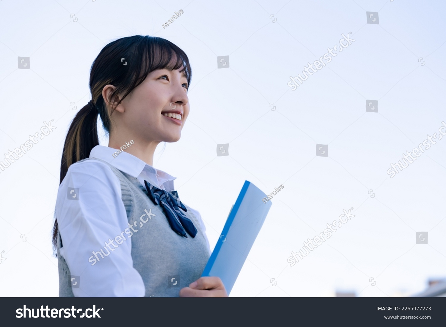 A high school girl in uniform looking far outside #2265977273