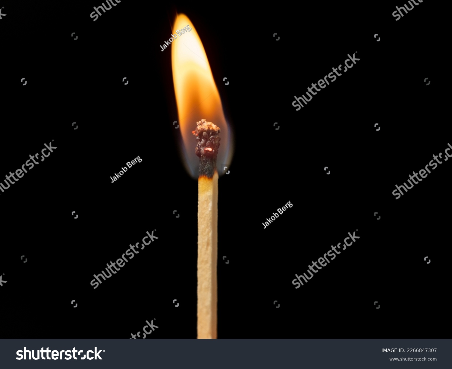 Burning match on a black background. Flame from a lit match. Close-up. #2266847307