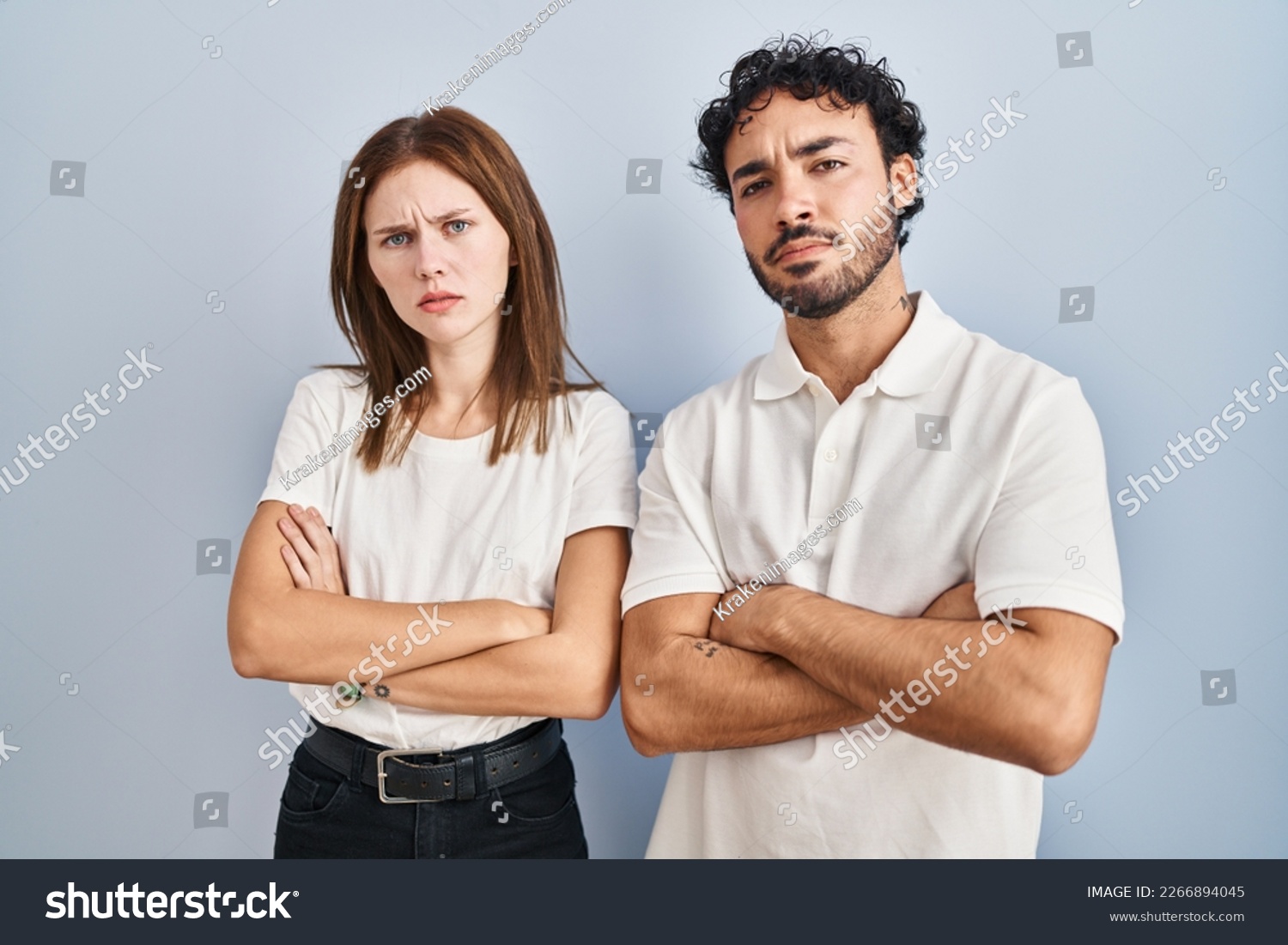 Young couple wearing casual clothes standing together skeptic and nervous, disapproving expression on face with crossed arms. negative person.  #2266894045
