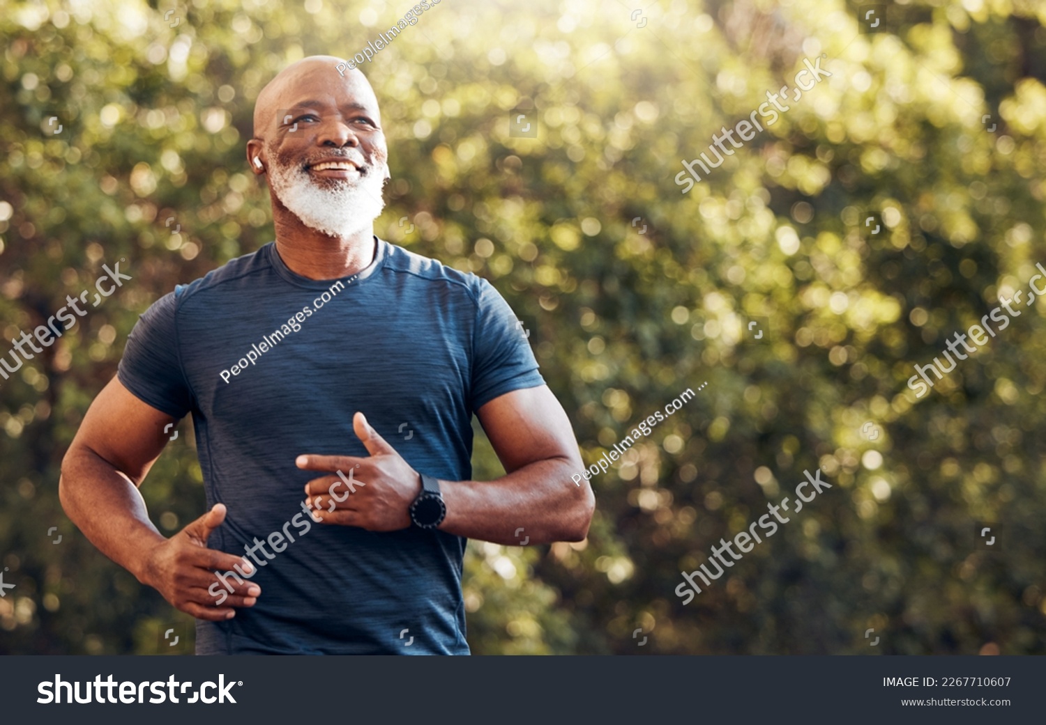 Happy black man running in park with music, smile and mockup in nature, garden and workout. Senior male, outdoor runner and motivation for fitness, energy and healthy exercise training with earphones #2267710607