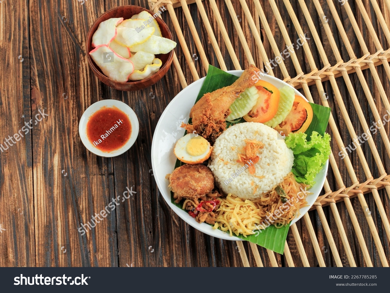 Top Vie Nasi Uduk, Typical Indonesian Food for Breakfast. Steamed Rice Cooked with Coconut Milk, Served with Fried Chicken. Eggs, Tempeh Oreg, and Bihun #2267785285