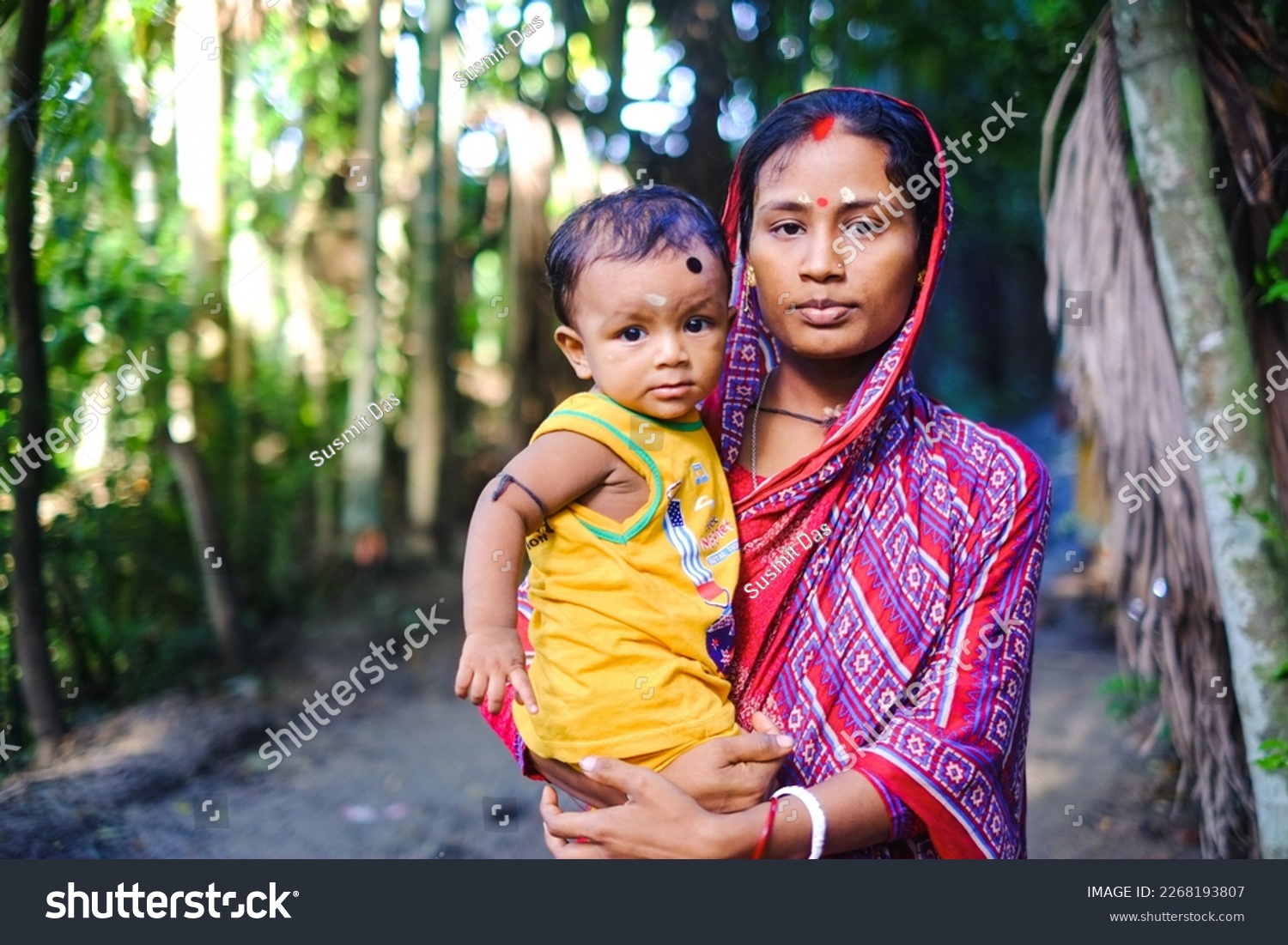 South asian hindu religious young mother holding her son, Child marriage is a problem, early maternity  #2268193807