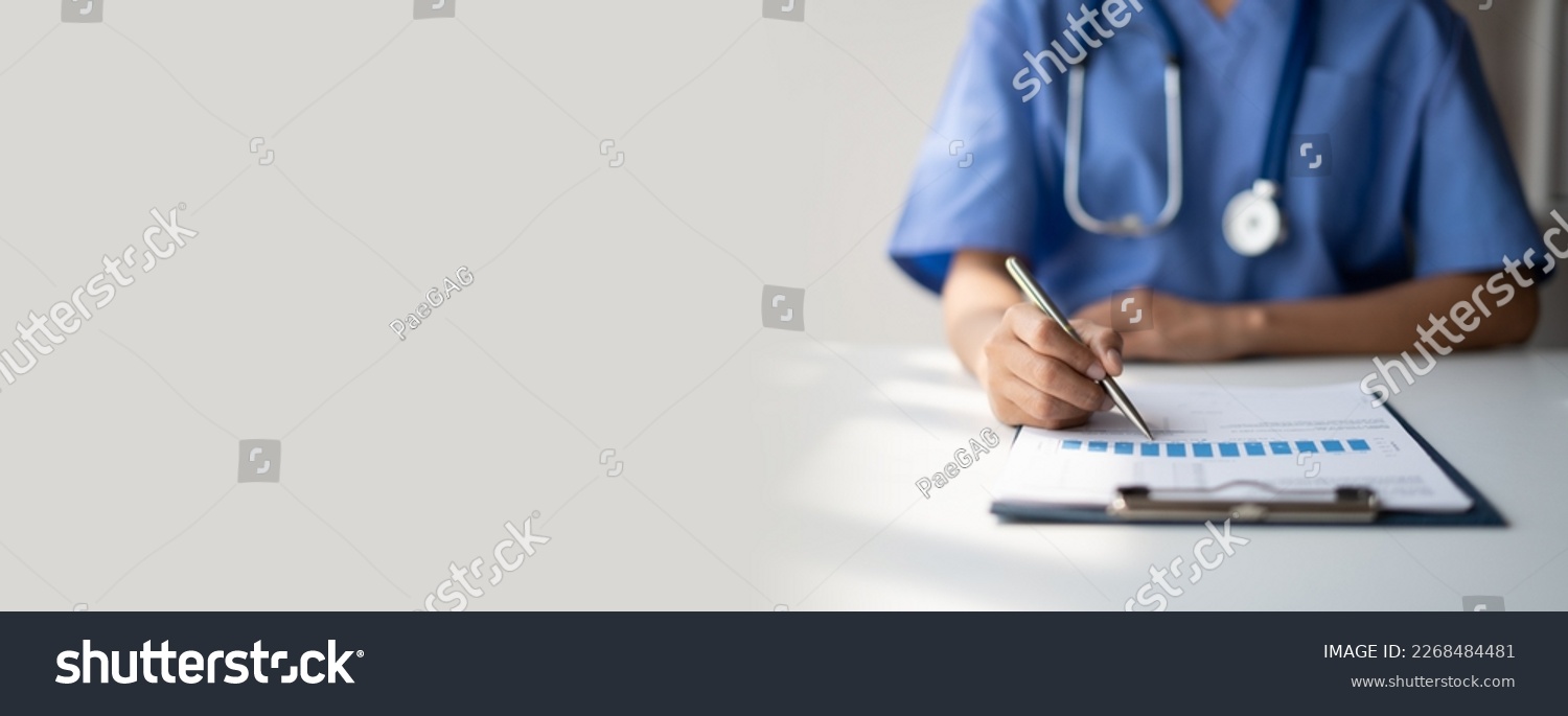 Doctor writing on a prescription note. copy space. #2268484481