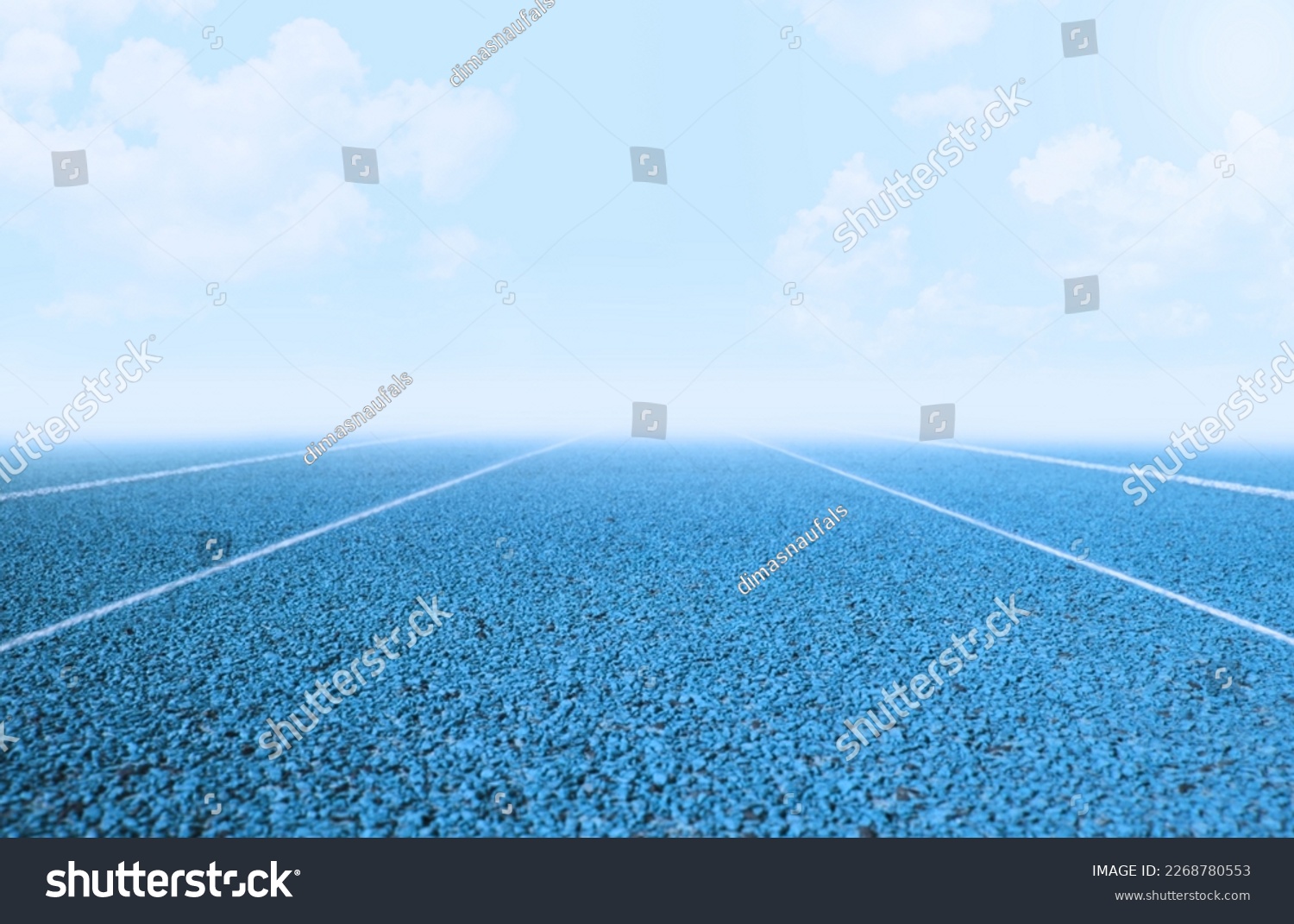 Blue running track with separate white line in straight area #2268780553