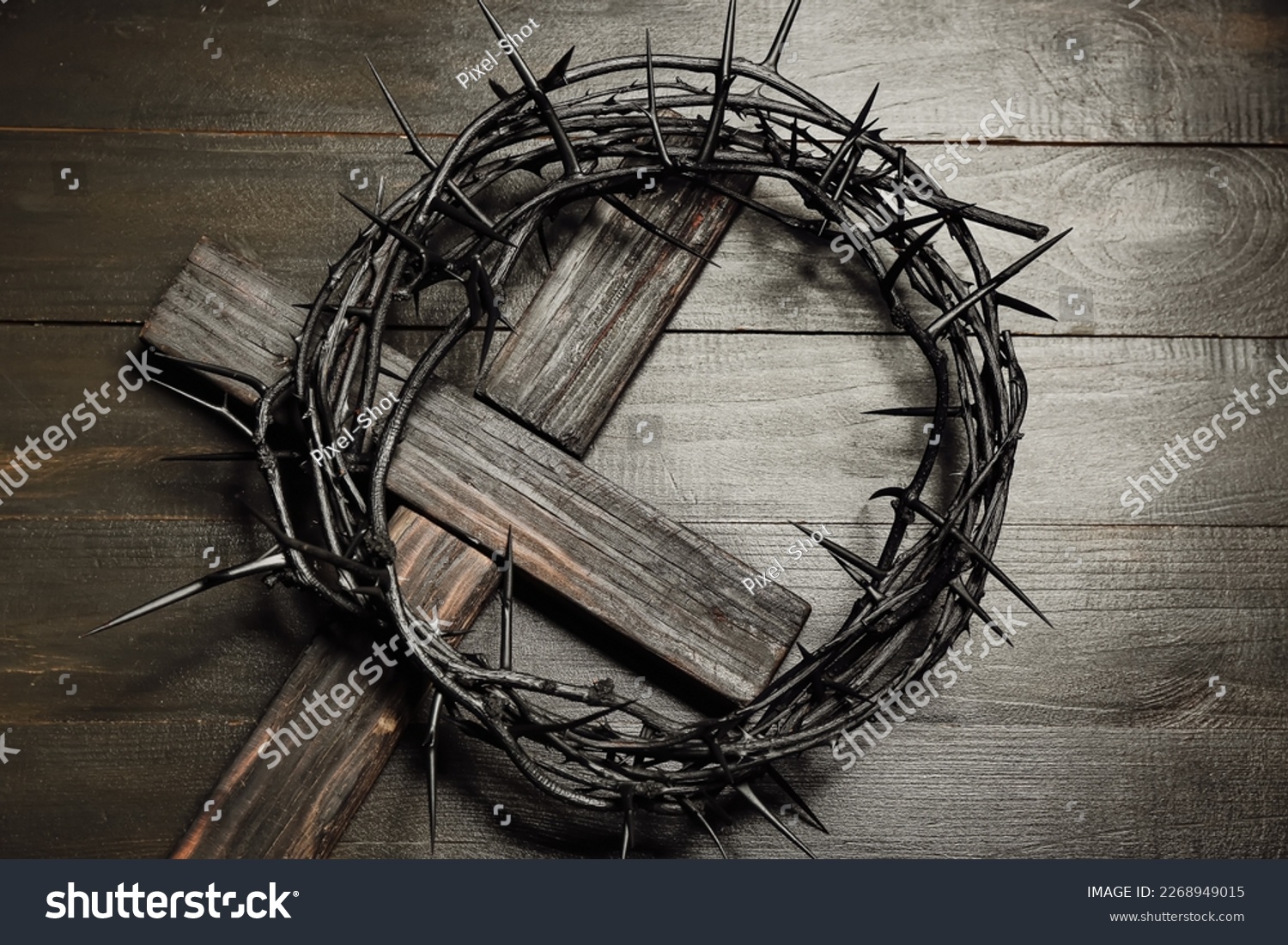 Crown of thorns with cross on dark wooden background #2268949015