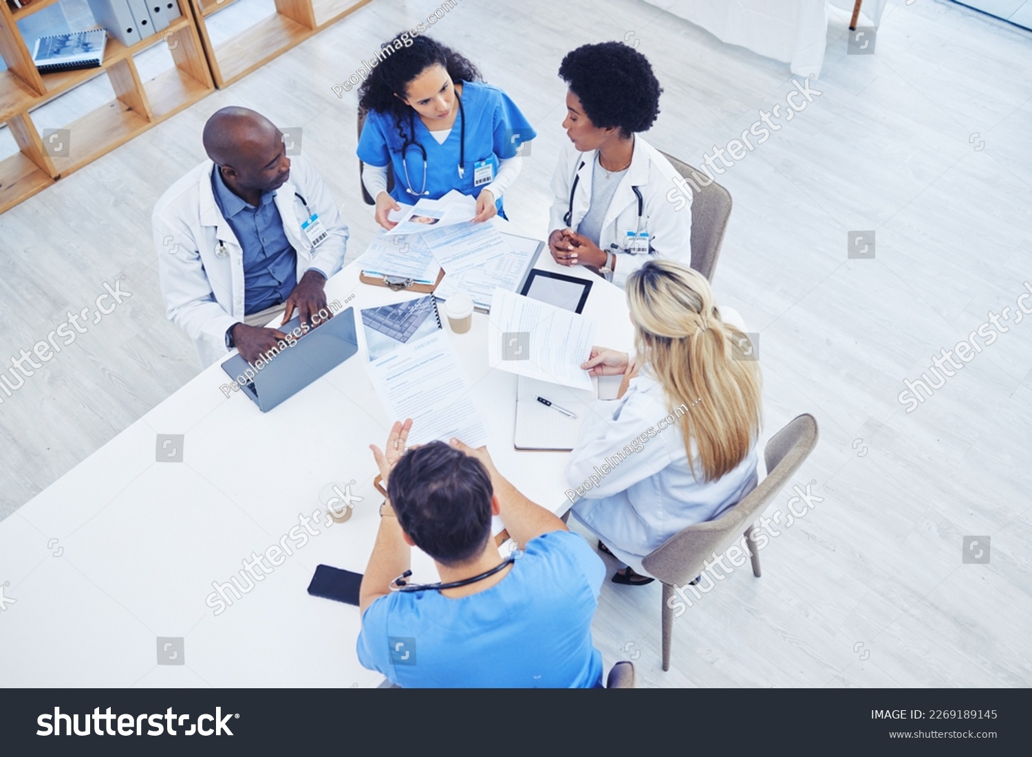 Above, healthcare and meeting by doctors on laptop for research, planning and innovation at hospital. Doctor, team and health experts brainstorm, problem solving or discussing online project together #2269189145