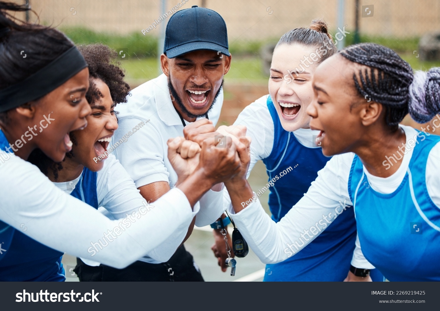 Fist, motivation or team support in netball training game screaming with hope or faith on sports court. Teamwork, fitness coach or group of excited athlete girls with pride or solidarity together #2269219425