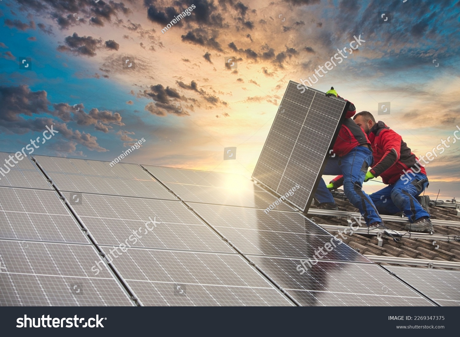 Installing solar photovoltaic panel system. Solar panel technician installing solar panels on roof. Alternative energy ecological concept. #2269347375