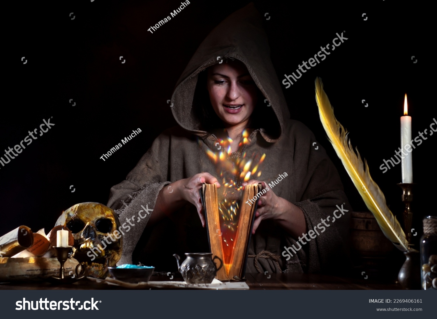 Sorceress with magic book and fairy dust #2269406161
