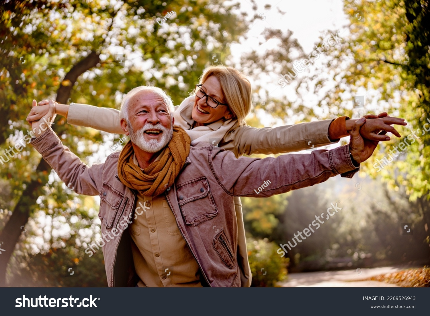 Cheerful pensioners enjoying their life together having fun outdoors in the park #2269526943