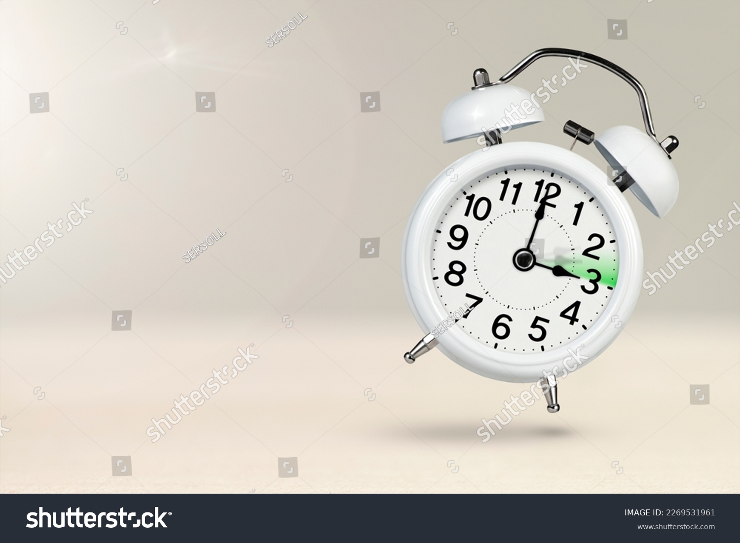Change time. Summer time concept, on a wooden background. A white alarm clock with a minute hand indicates that the time has been moved forward an hour with copy space. #2269531961