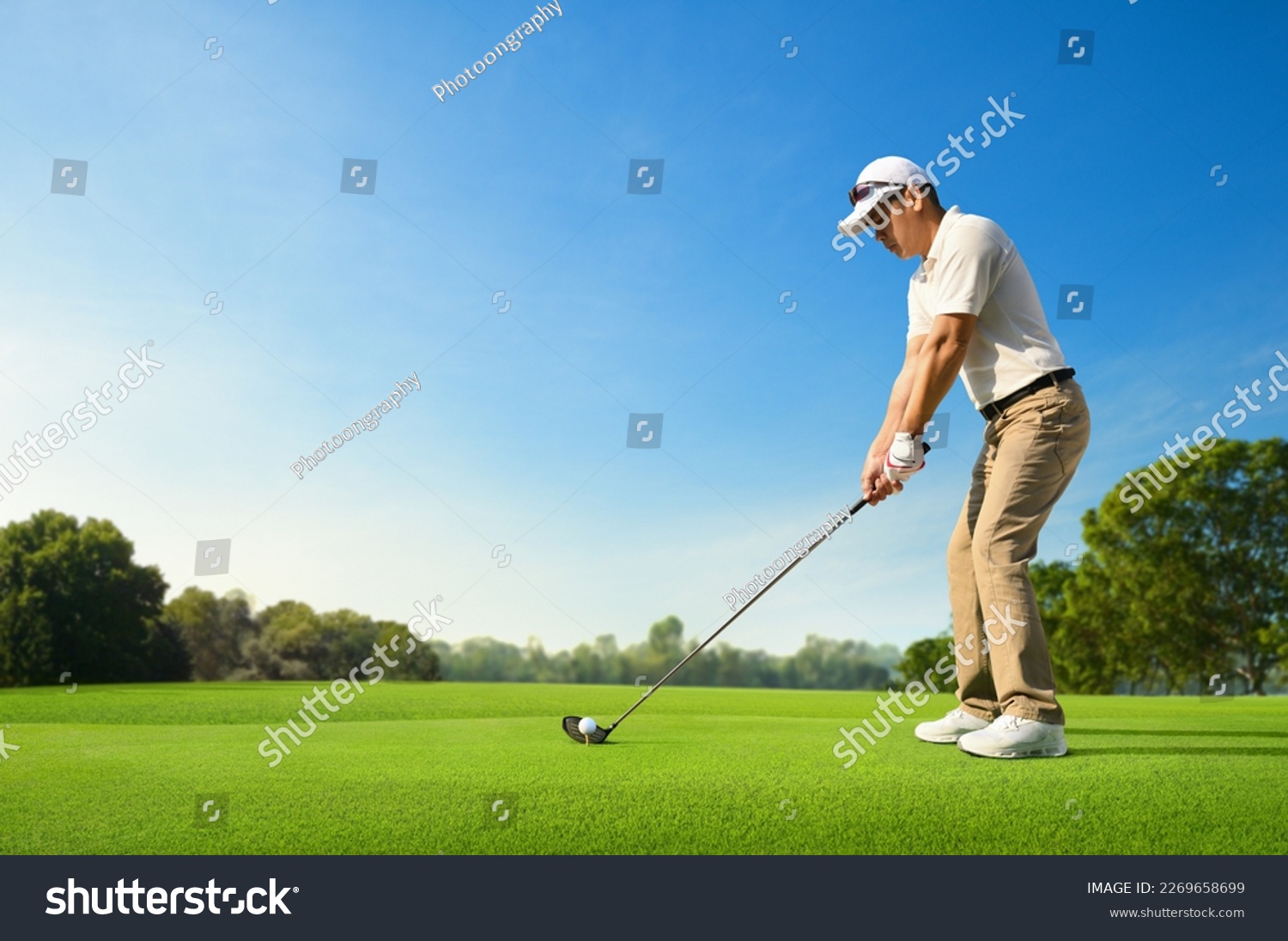 Golfer ready tee-off with drivers on golf teeing ground. #2269658699