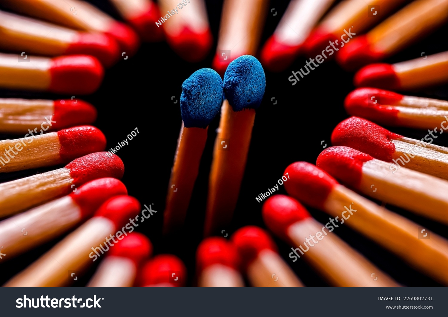 Red match heads are lined with a heart with two blue match heads inside. Matches close-up. Red and blue matches #2269802731