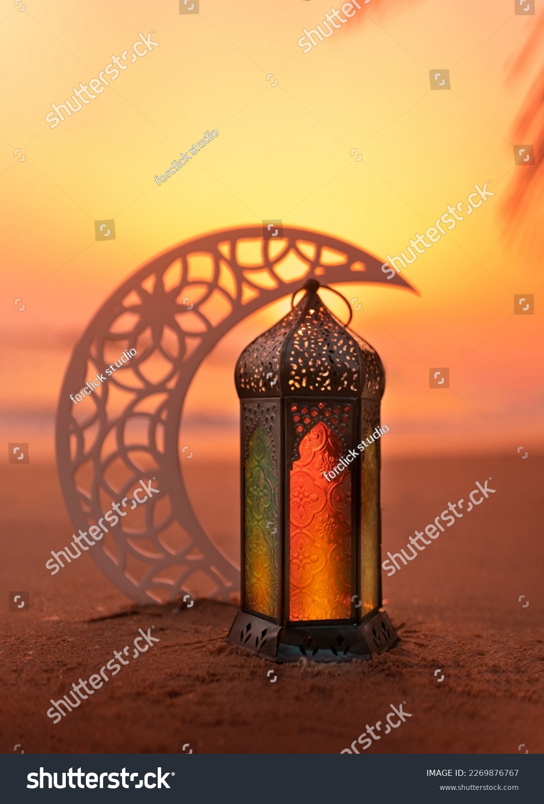 Ramadan Lantern on the beach with crescent moon shape during sunset, 2024 Islamic concept image, Eid Mubarak Greeting background #2269876767