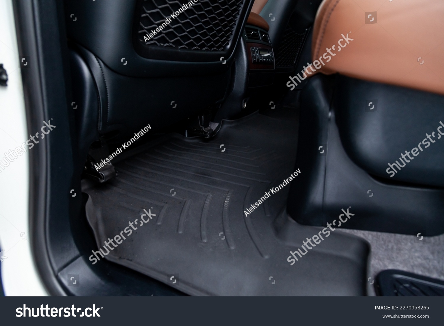 Clean car floor mats of black rubber under rear passenger seat in the workshop for the detailing vehicle dry cleaning. Auto service industry. Interior of sedan. #2270958265