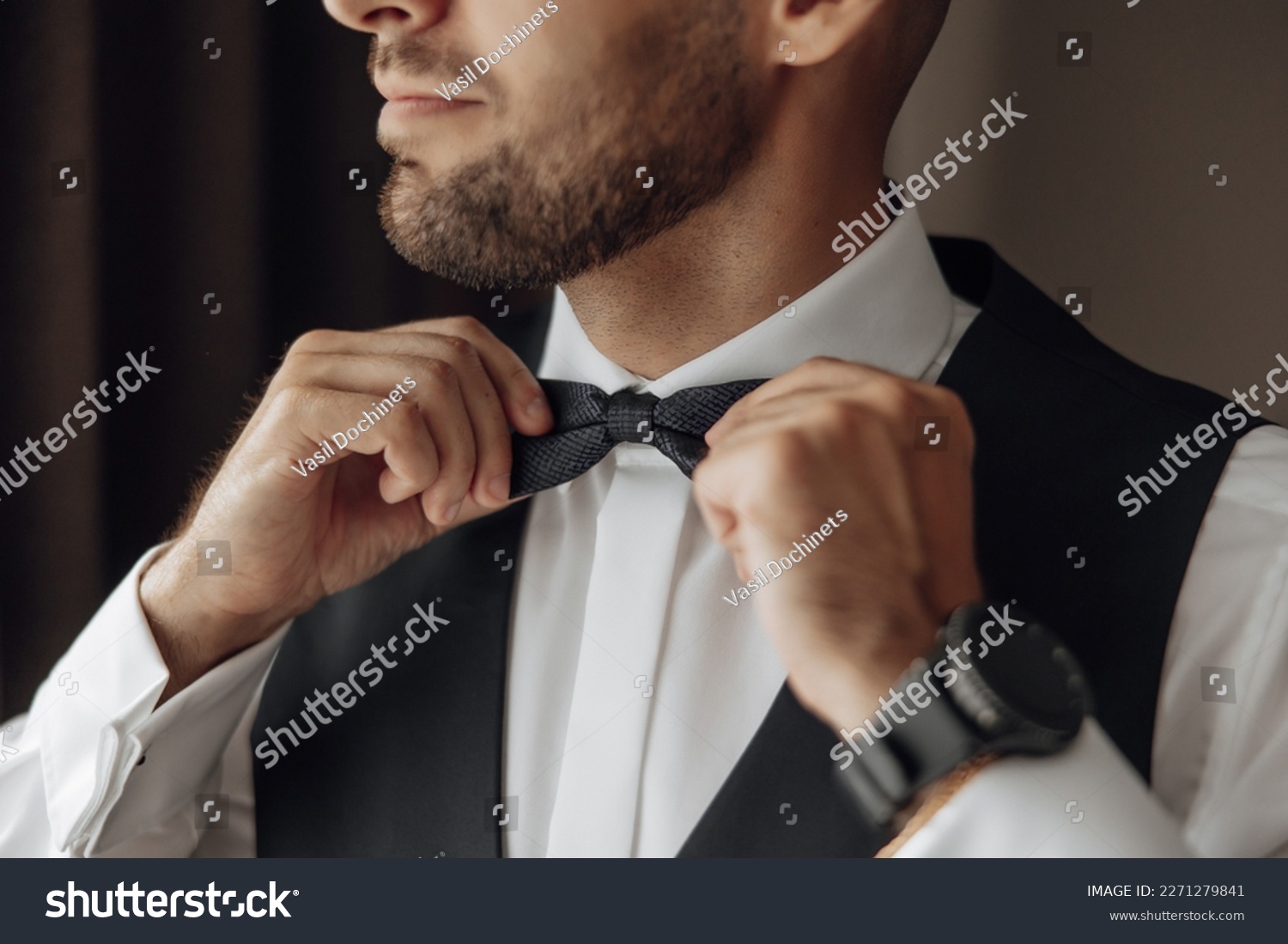 The stylish bridegroom dresses, prepares for the wedding ceremony. The groom's morning. Businessman wears a jacket, male hands closeup, groom getting ready in the morning before wedding ceremony #2271279841