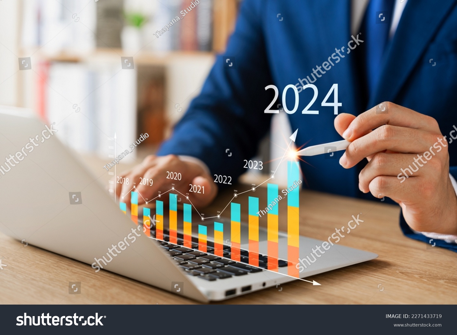 Businessman analyzes profitability of working companies with digital augmented reality graphics, positive indicators in 2024, businessman calculates financial data for long-term investments. #2271433719