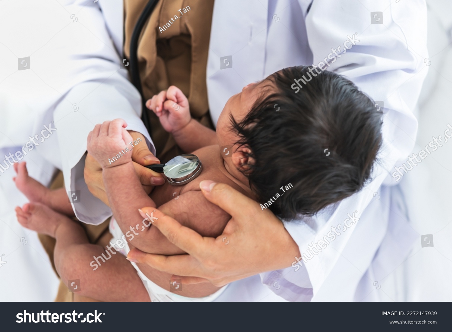 doctor woman using a stethoscope, checking the respiratory system and heartbeat of a 1-month-old baby newborn, who is half Nigeria half Thai, to Infant health care concept. #2272147939