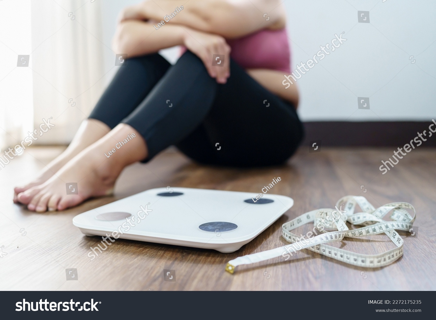 Obese Woman with fat upset bored of dieting Weight loss fail  Fat diet and scale sad asian woman on weight scale at home weight control. #2272175235