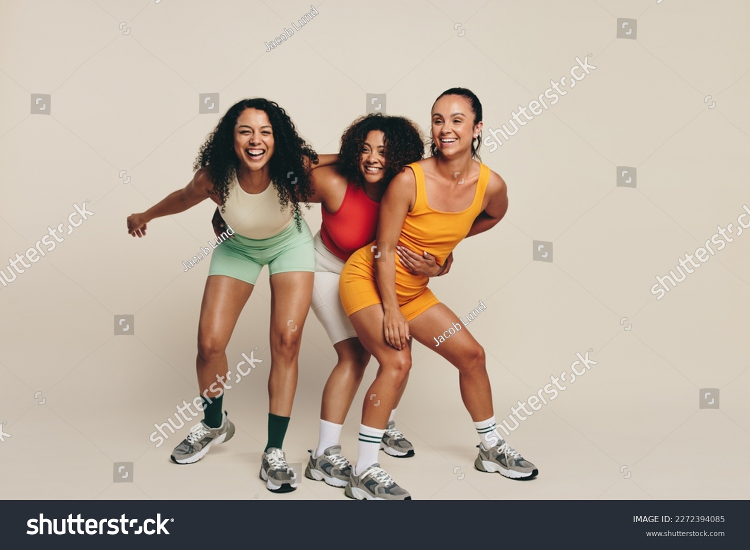 Group of young female athletes laughing and having fun in fitness clothing, celebrating their love for sport and exercise. Happy young sportswomen demonstrating their commitment to a healthy lifestyle #2272394085