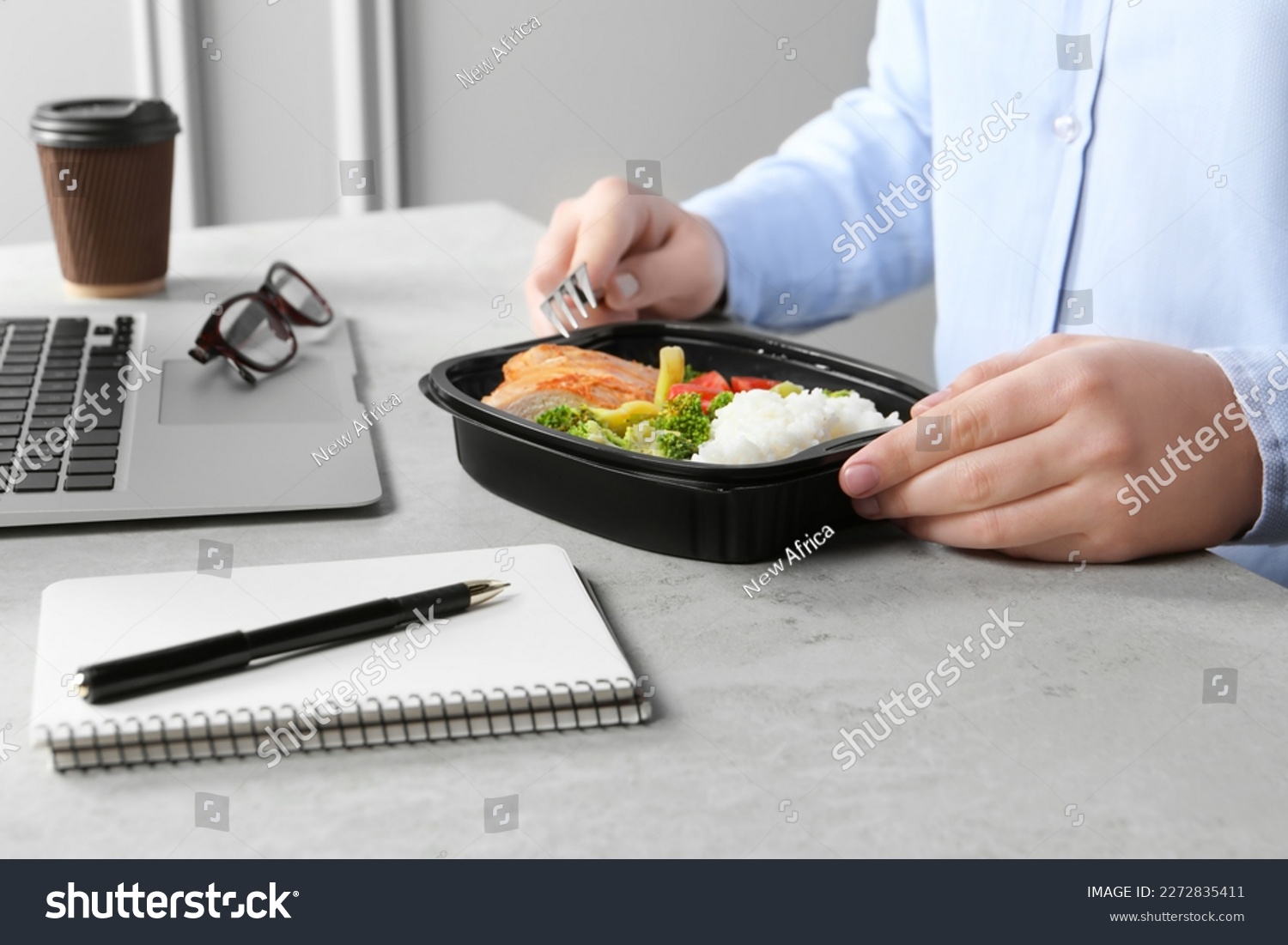 Office employee having business lunch at workplace, closeup #2272835411