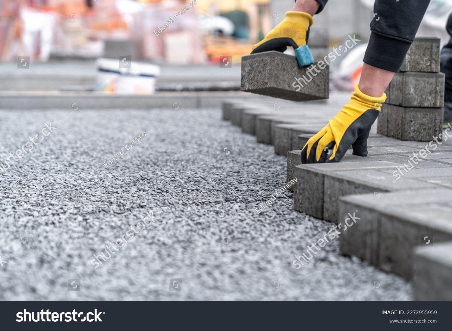 laying interlocking pavers during the construction of sidewalks and roads. copy space #2272955959