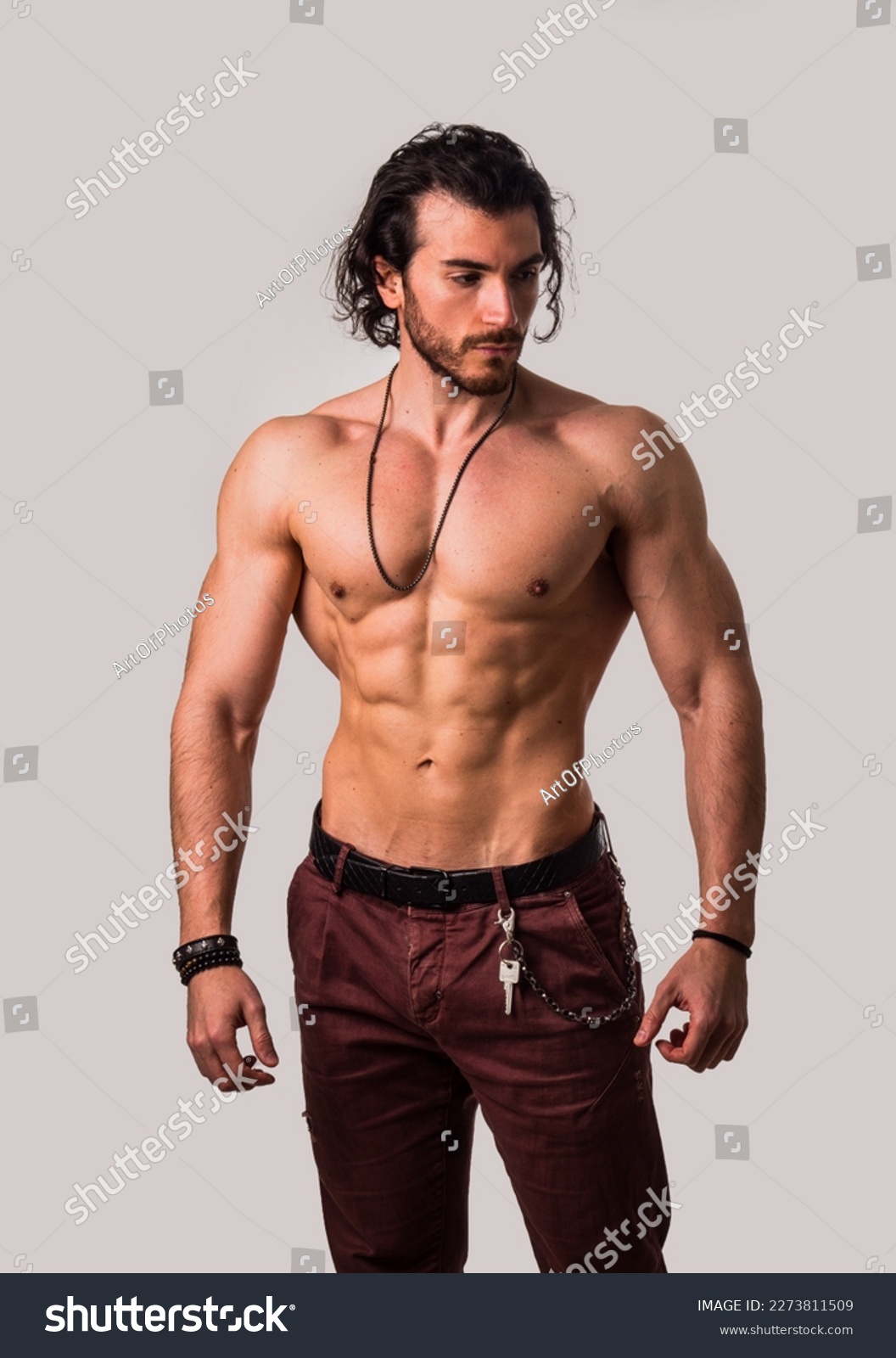 Confident, attractive shirtless muscular young man with open vest on #2273811509