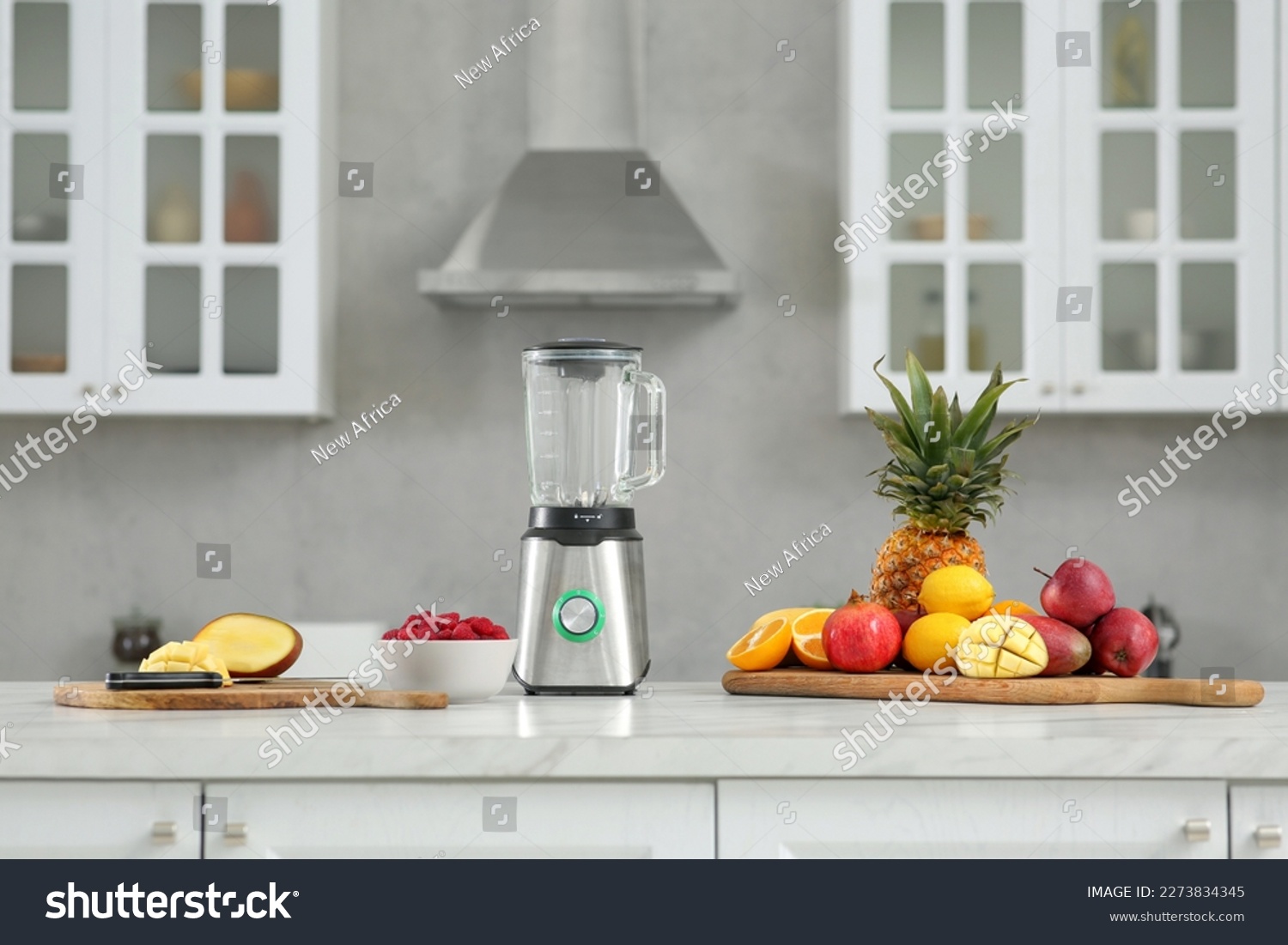 Blender and smoothie ingredients on white marble countertop in kitchen #2273834345
