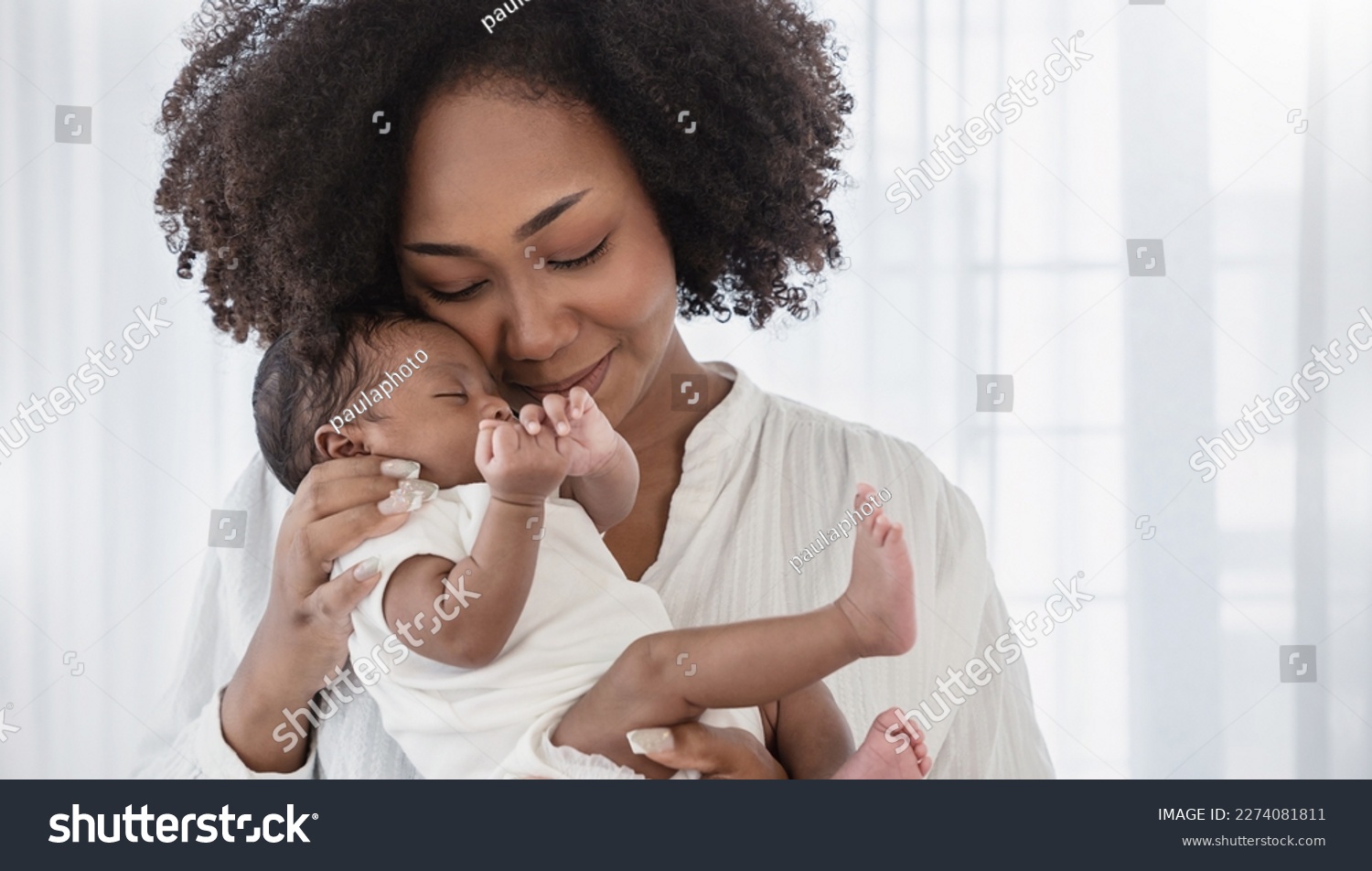 Close up portrait of beautiful young African American  mother holding sleep newborn baby in hospital bed room. Healthcare medical love black afro woman lifestyle mother's day, breast with copy space.  #2274081811