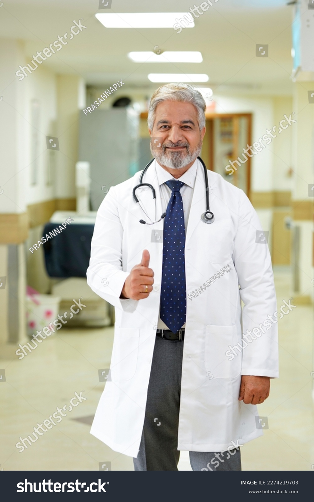 Indian male doctor showing thumps up at hospital. #2274219703