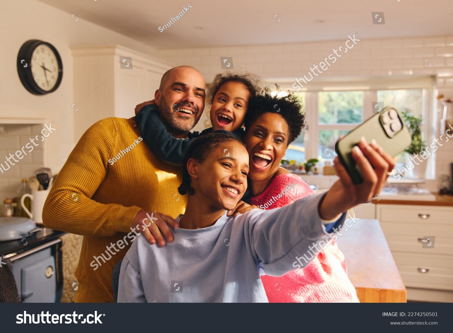 Teen girl taking selfie on phone with happy smiling family #2274250501