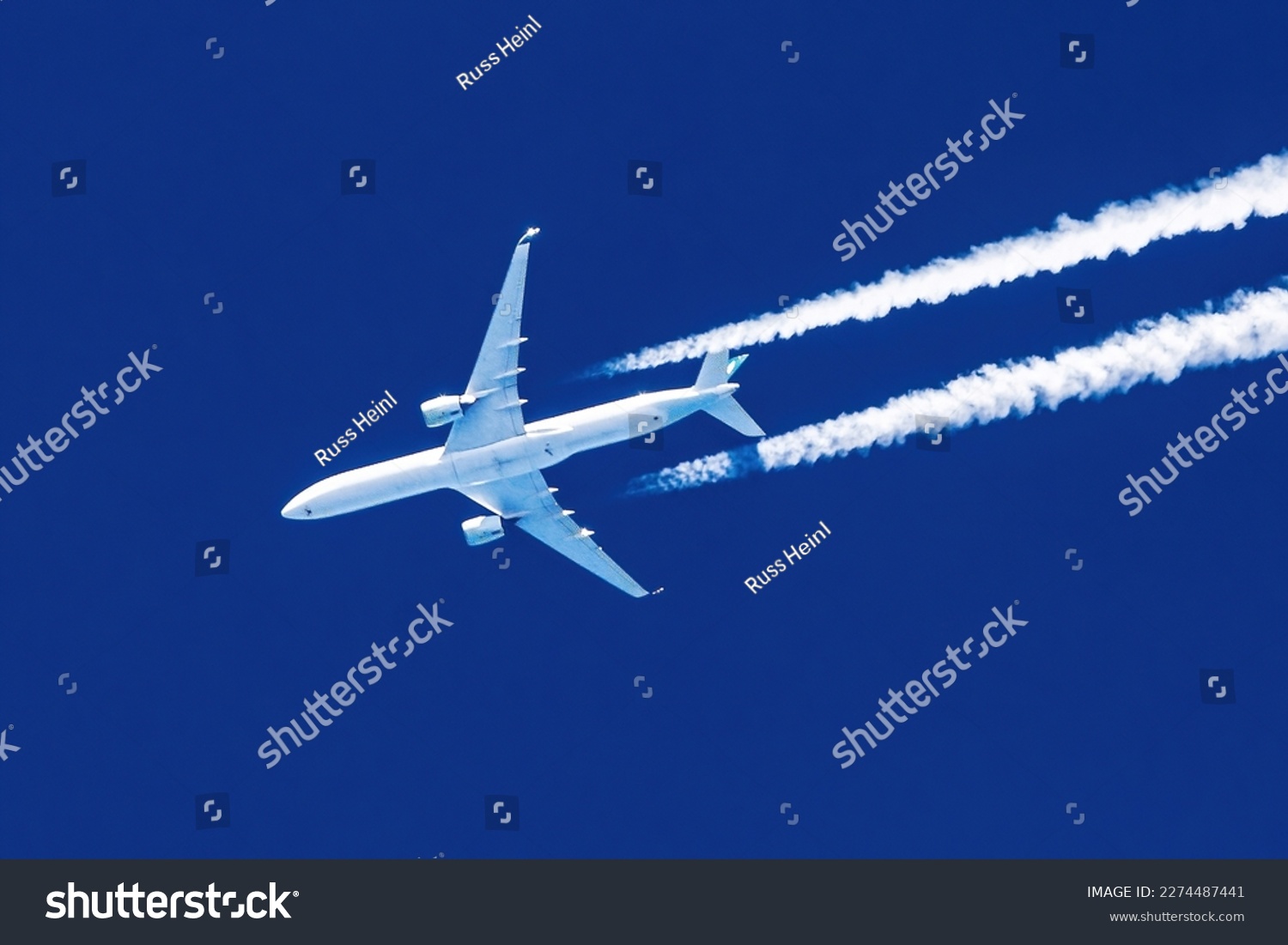 Sharp telephoto close-up of jet plane aircraft with contrails cruising from Hong Kong to New York, altitude AGL 37,000 feet, ground speed 588 knots. #2274487441