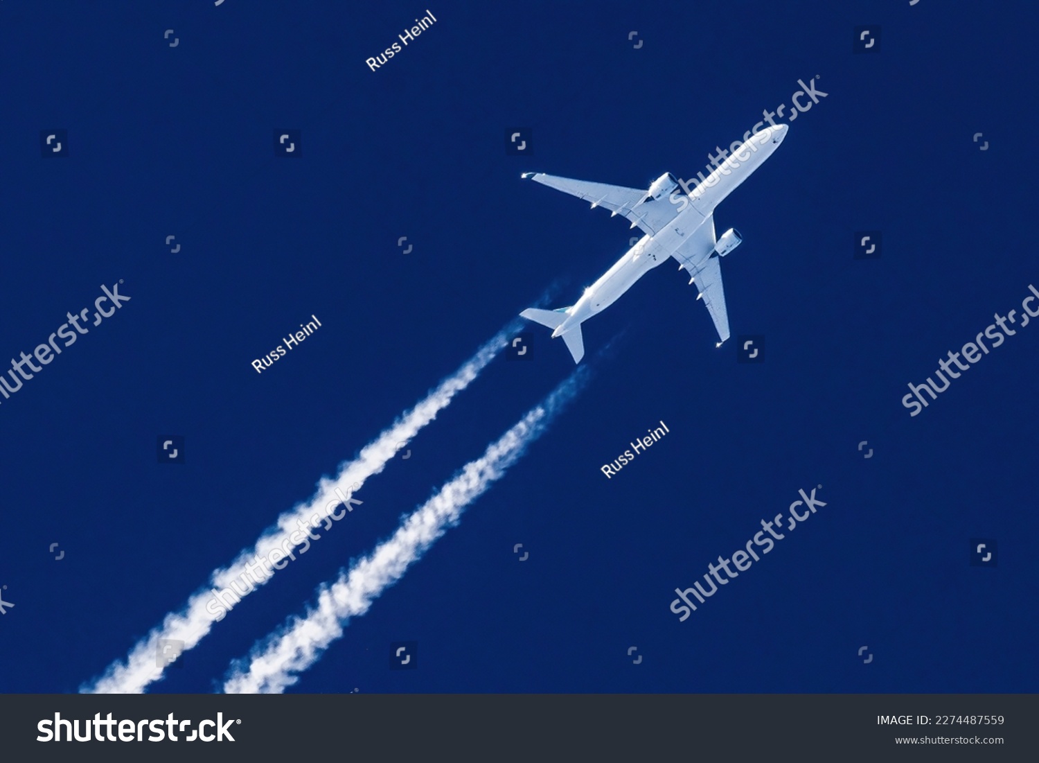 Sharp telephoto close-up of jet plane aircraft with contrails cruising from Hong Kong to New York, altitude AGL 37,000 feet, ground speed 554 knots #2274487559